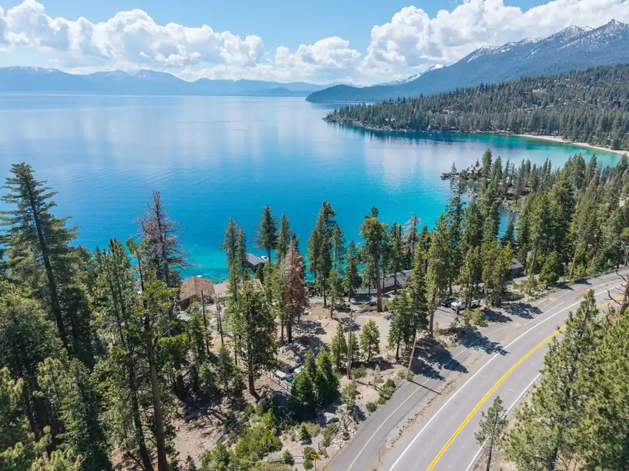 Aerial view of a Lake Tahoe lakefront home and shoreline road