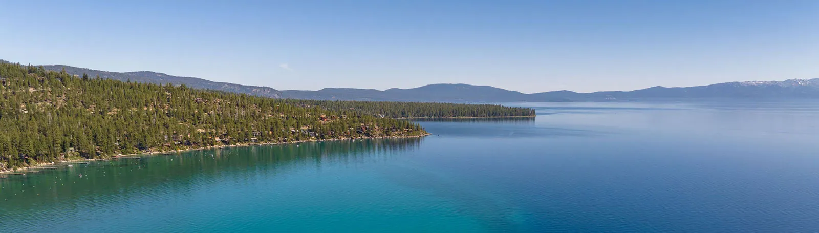 Lake Tahoe shoreline with homes across multiple jurisdictions