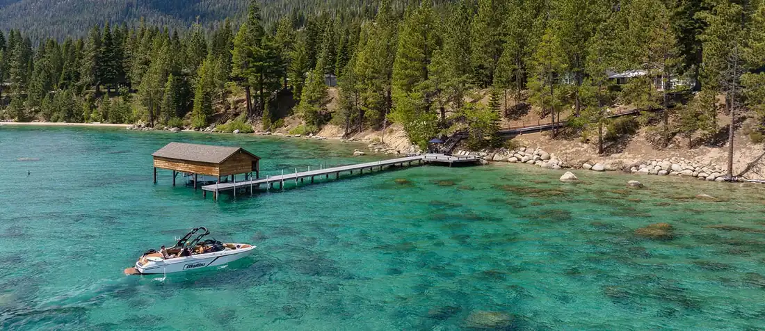 Snow-covered Lake Tahoe mountain home with steep roof